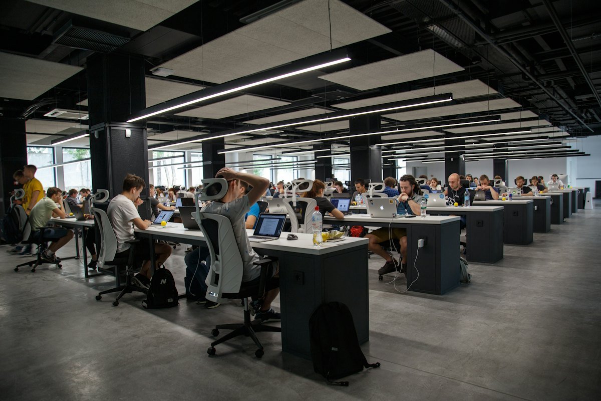 Open plan office floor with staff working at their workstations